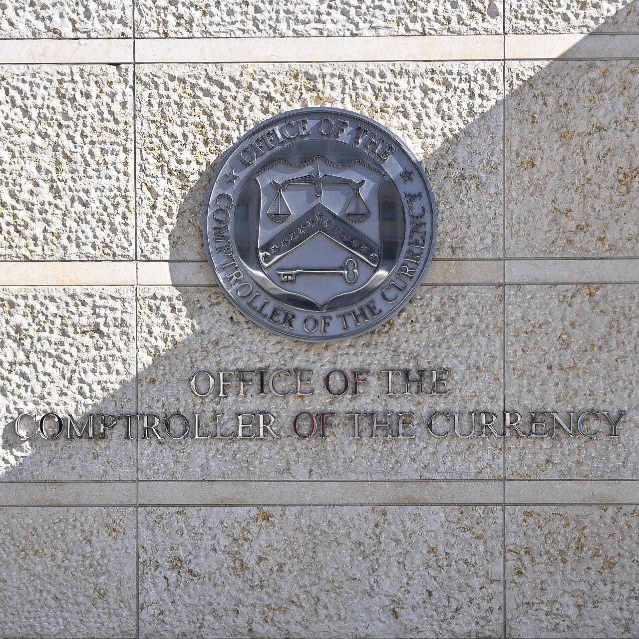 1280px-Comptroller_of_the_Currency_wall_logo_Washington_DC_2025-02-10_13-19-10