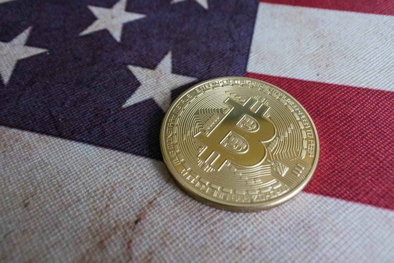 Bitcoin and United States of America Flag. Concept for investors in cryptocurrency and Blockchain Technology in United States of America.